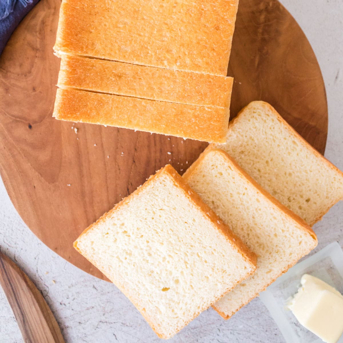 Overhead view of slices of pullman loaf bread on a cutting board.