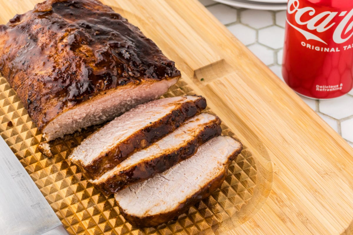 Finished pork loin on a cutting board.