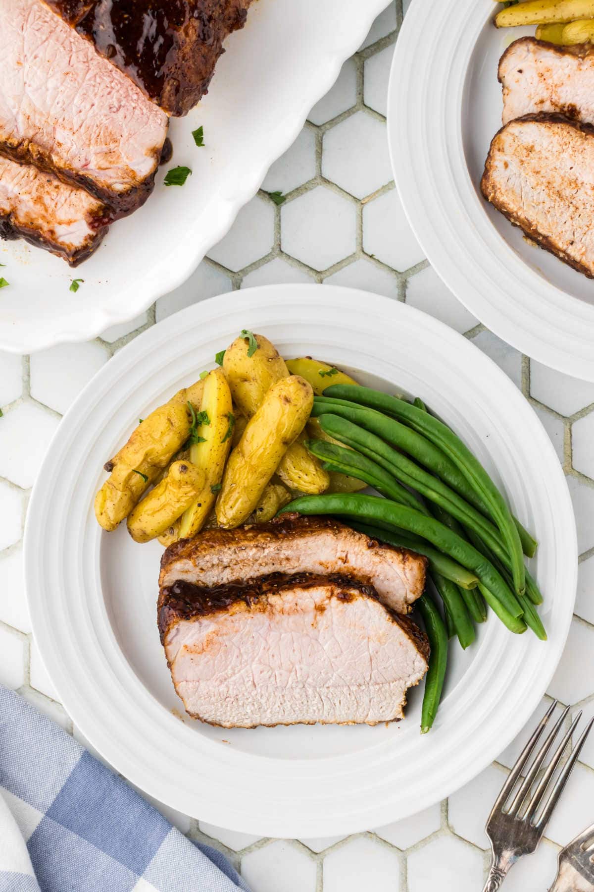 Slices of pork loin served on a white plate.