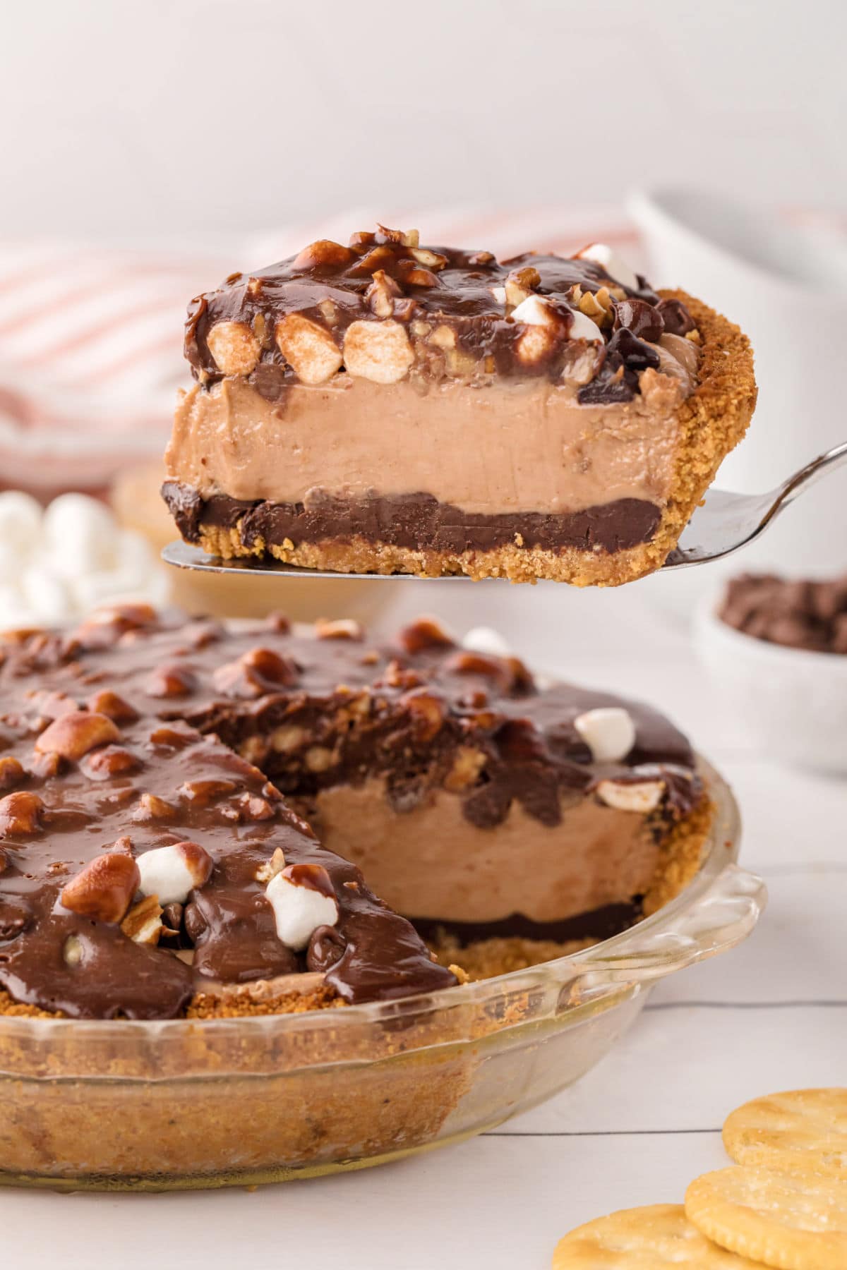 A slice of peanut butter and chocolate pie being lifted from the pie plate.