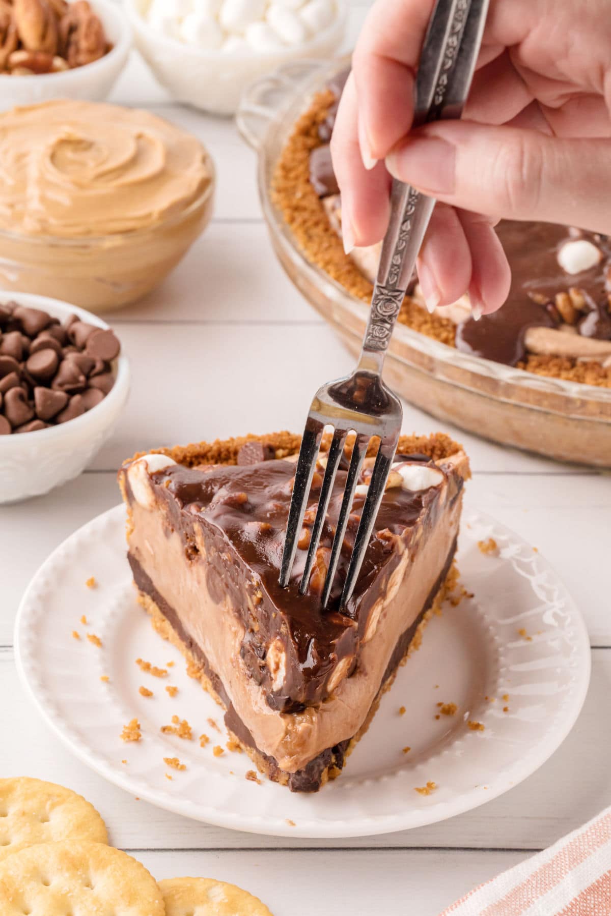 A slice of pie on a white plate with a fork.