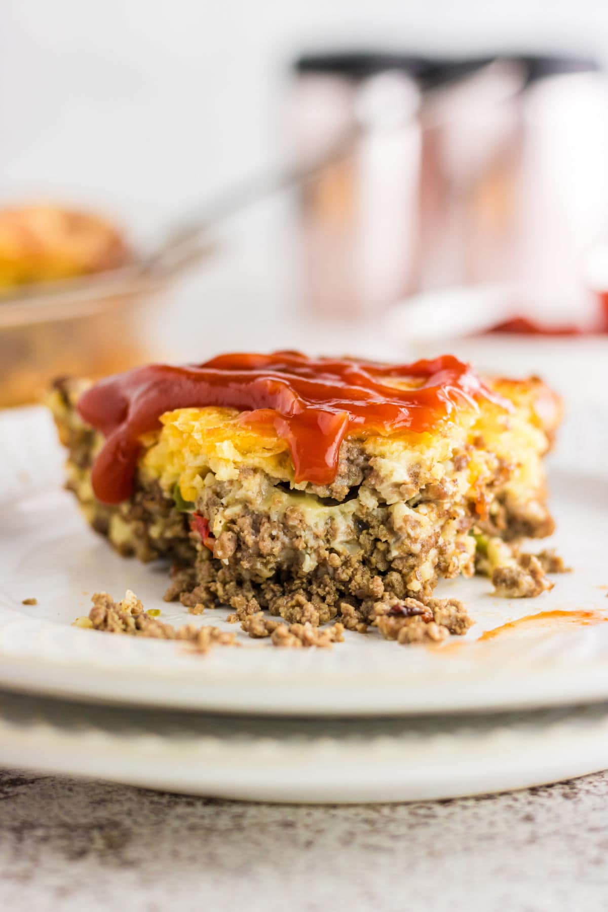 Side view of a slice of the pie showing the layers of ground beef and cheese.