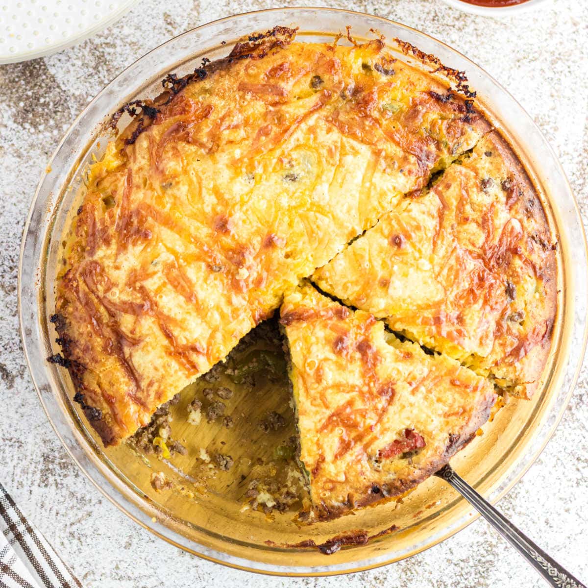 Overhead view of the cheeseburger pie sliced into servings.