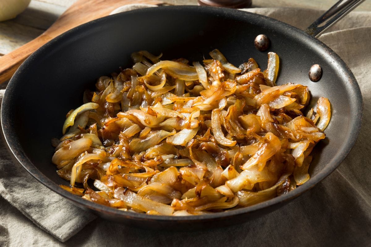 Caramelized onions in a black skillet.