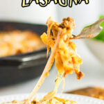 Lasagna on a fork with a long cheese stretch to the plate and a text overlay for Pinterest.