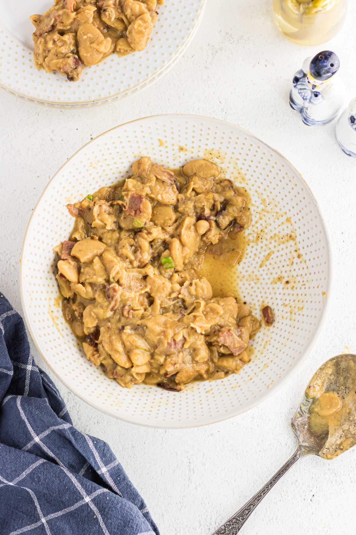 Butter beans being served at the table.