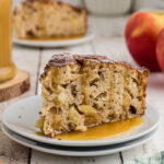A slice of Irish apple cake being served on a white plate.
