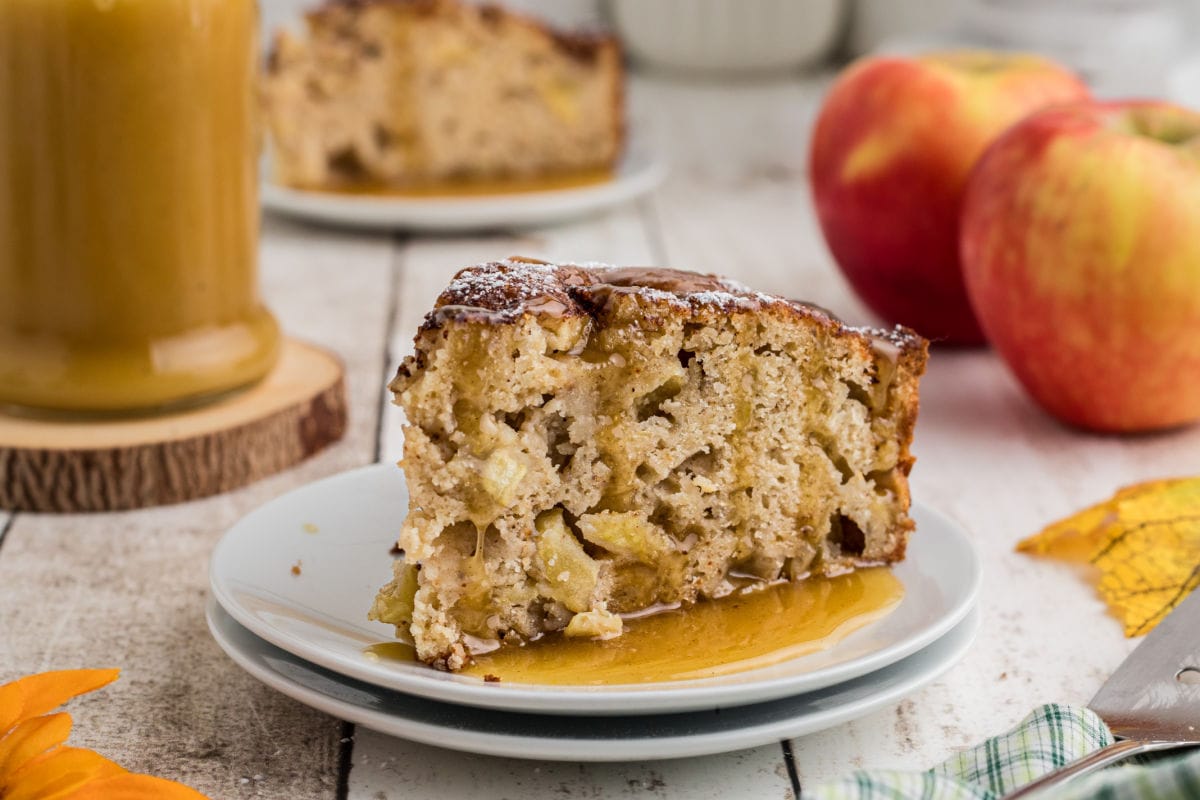 A slice of Irish apple cake being served on a white plate.