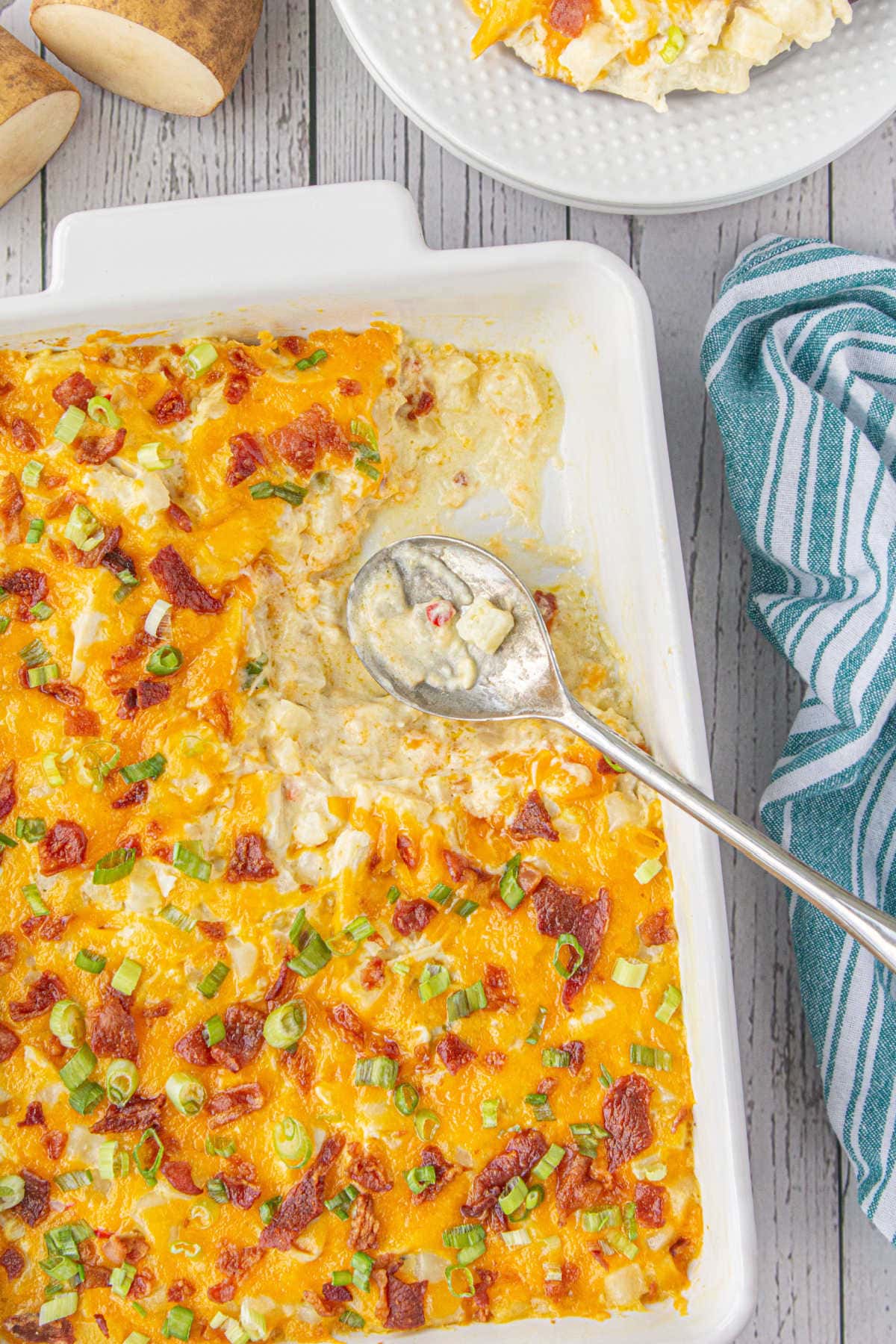 Casserole dish with some of the creamy chicken casserole removed.