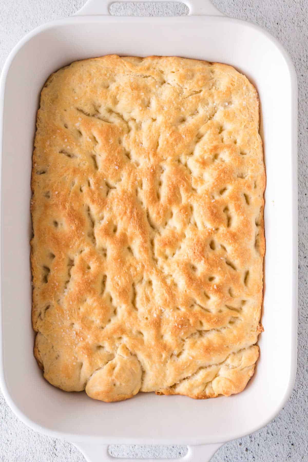 Overhead view of baked focaccia in a casserole dish.