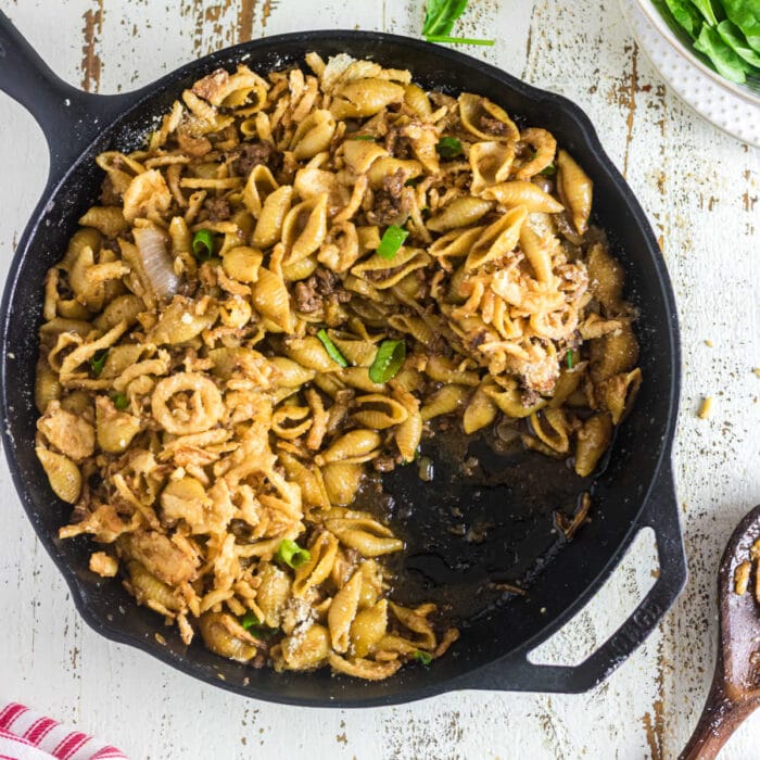 Overhead view of an iron skillet with hamburger french onion casserole in it.