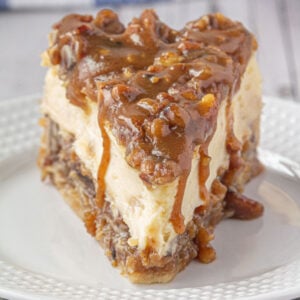 Closeup of pecan pie cheesecake on a plate.