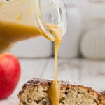 Brown butter whiskey sauce being poured over Irish Apple Cake with a title text overlay for Pinterest.