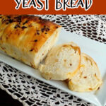 Title text on a brown background with an image of the sliced onion cheese bread on a white plate.