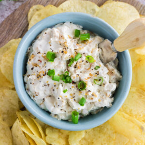 Overhead view of onion dip in a blue bowl.