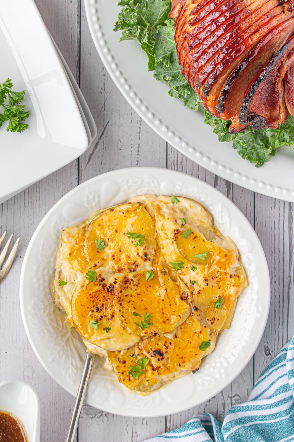 Cheesy potatoes on a white plate.