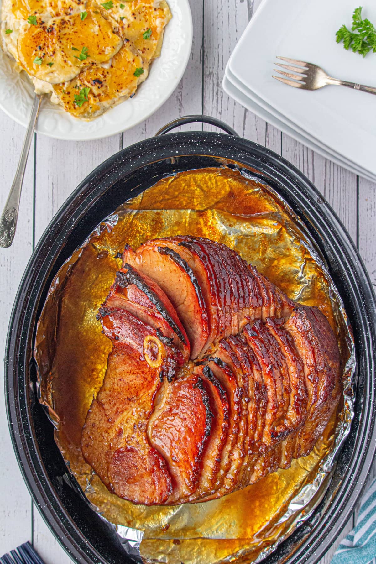 An overhead photo of the ham, glazed with cola, sliced with caramelized edges.