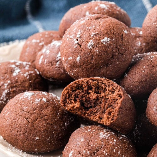 Closeup of chocolate butter cookies dusted with powdered sugar.