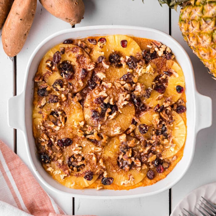 Overhead view of sweet potato pineapple casserole with cranberries and pecans.