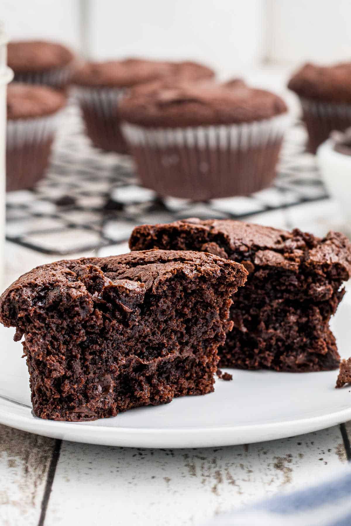 A broken in half muffin on a plate.