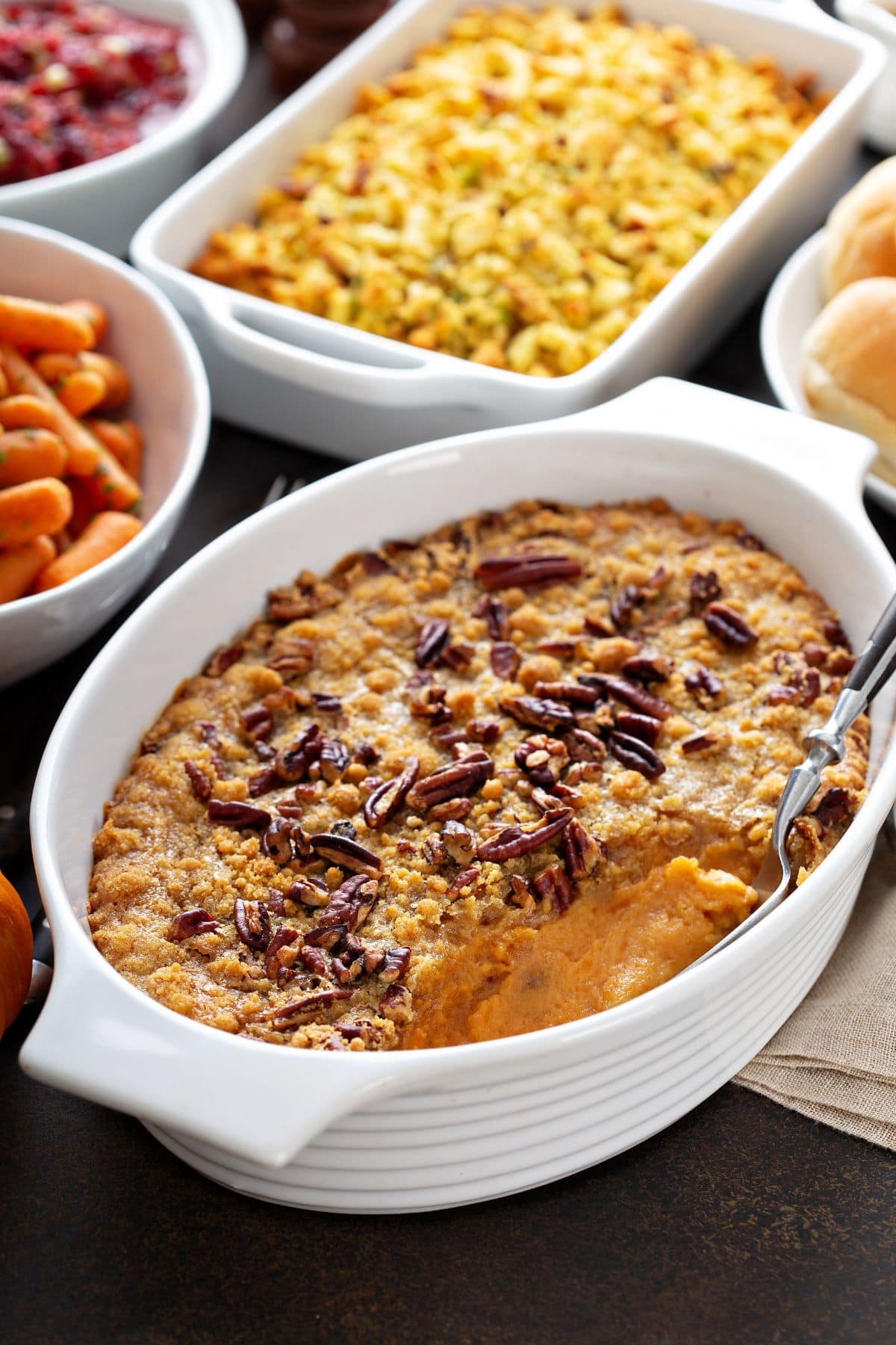 Several casseroles on a table at a potluck.