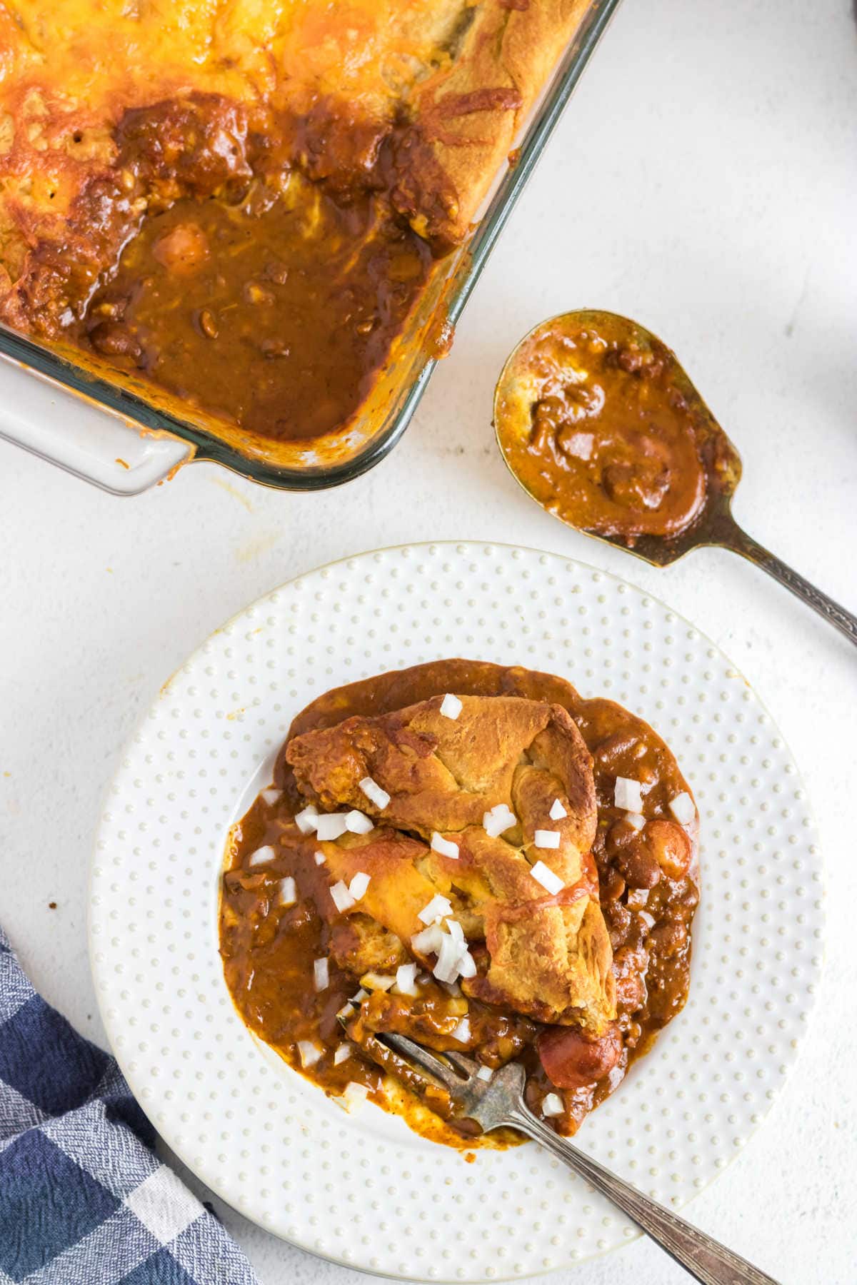 Overhead view of chili dog casserole served up on a plate.