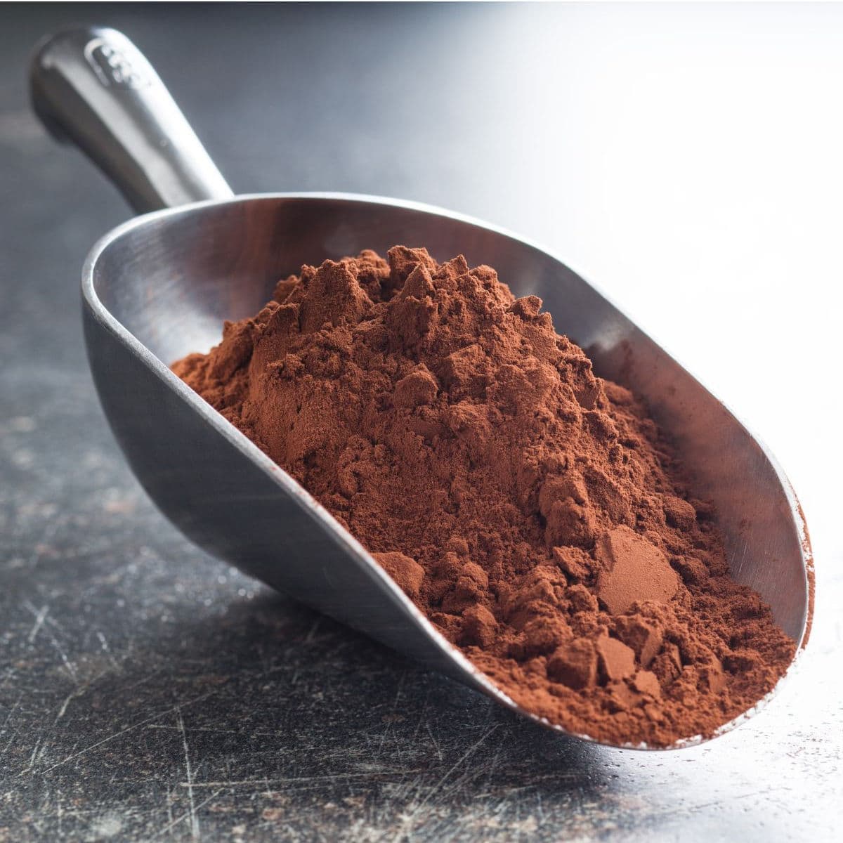 A scoop with cocoa powder in it.