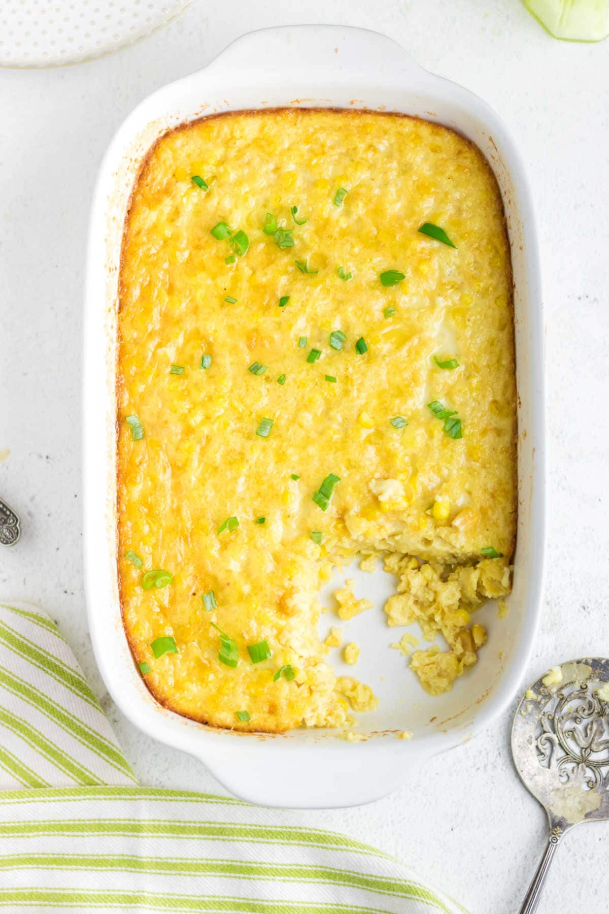 Overhead view of corn pudding casserole with a serving removed.