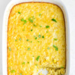 Corn pudding in a dish with a title text overlay for Pinterest.