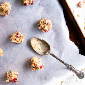 closeup of cookie dough on a baking sheet with a spoon.