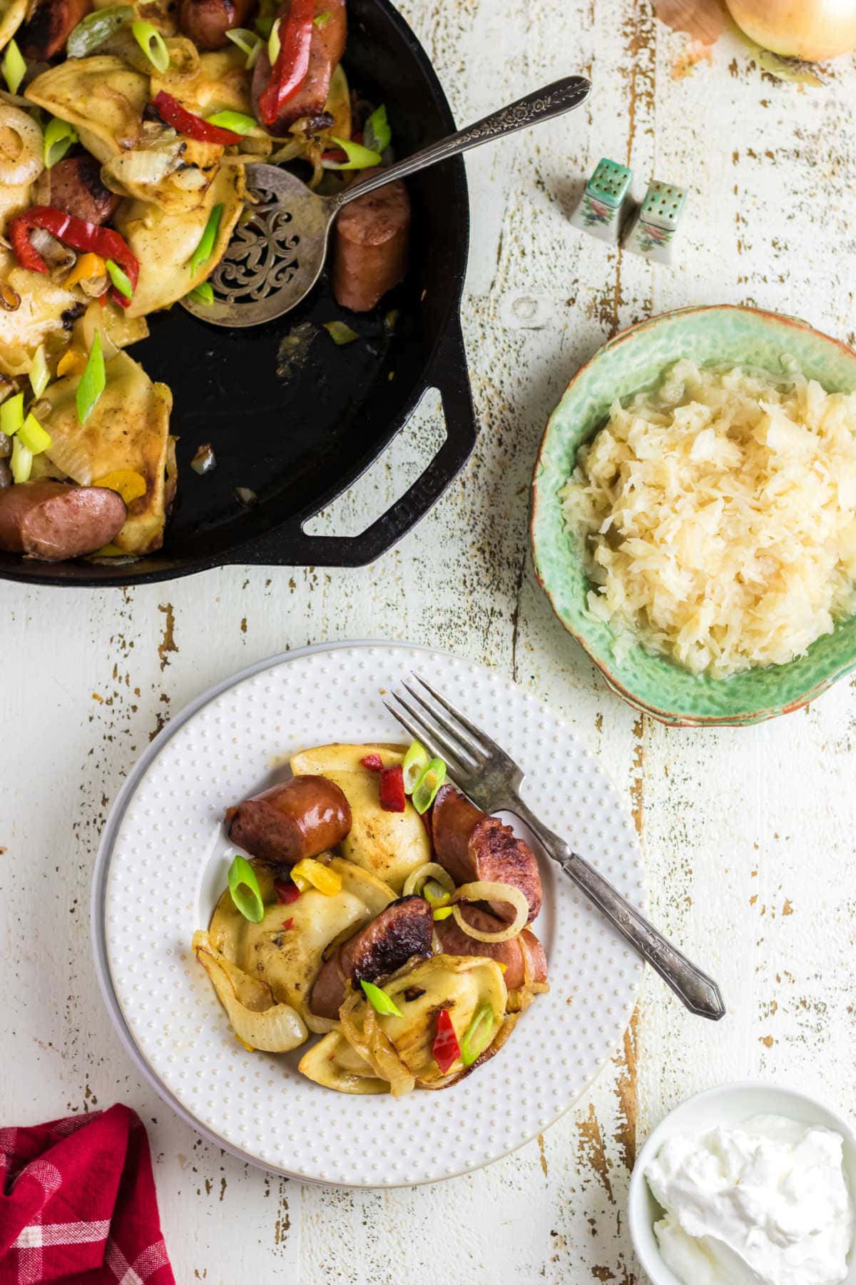 Overhead view of the kielbasa and pierogi on a plate.