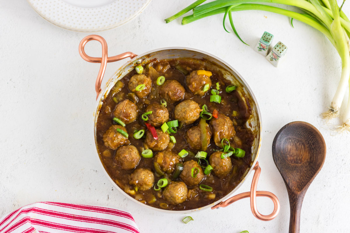 Overhead view of the finished meatballs in a pan.