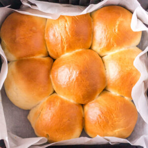 Closeup view of golden brown rolls in the air fryer.