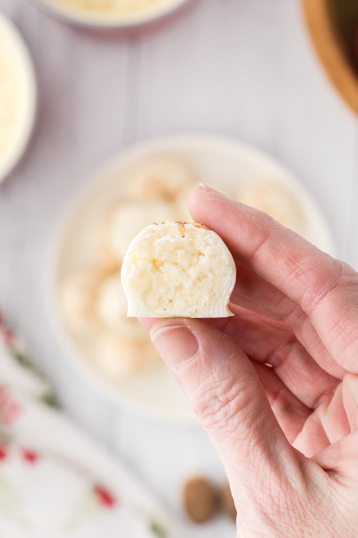 An overhead photo showing a creamy cross-section interior of one eggnog truffle.