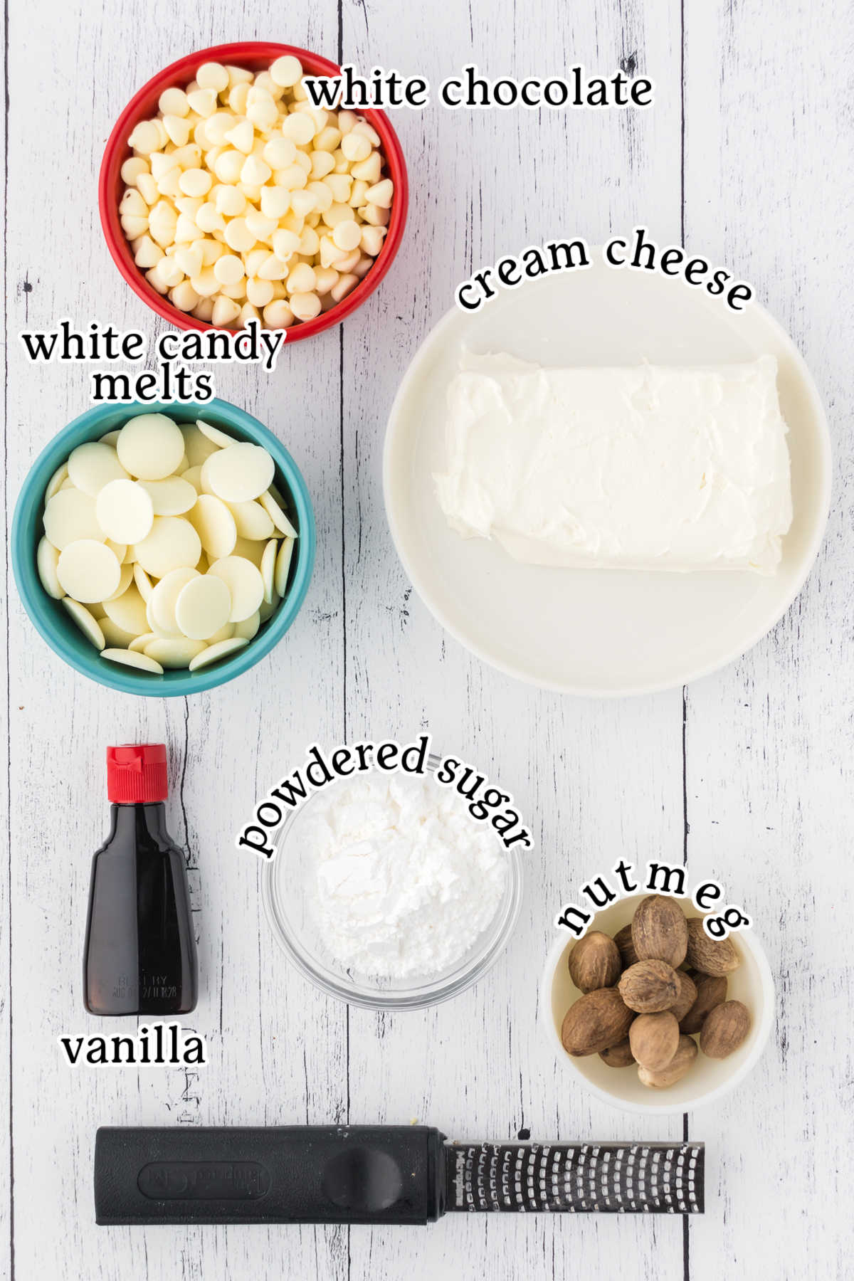 Eggnog truffle ingredients set on a white background next to a fine grater.