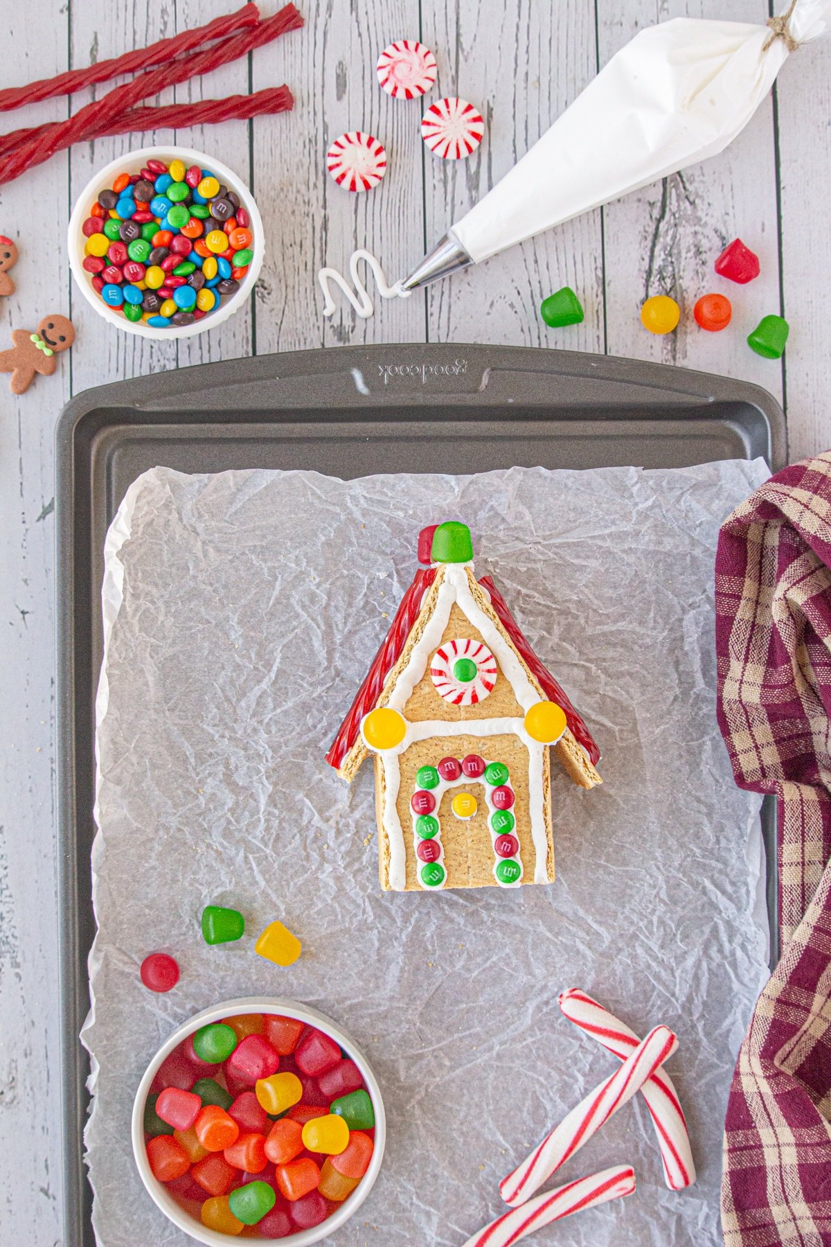 A finished gingerbread house showing the  decorated front.