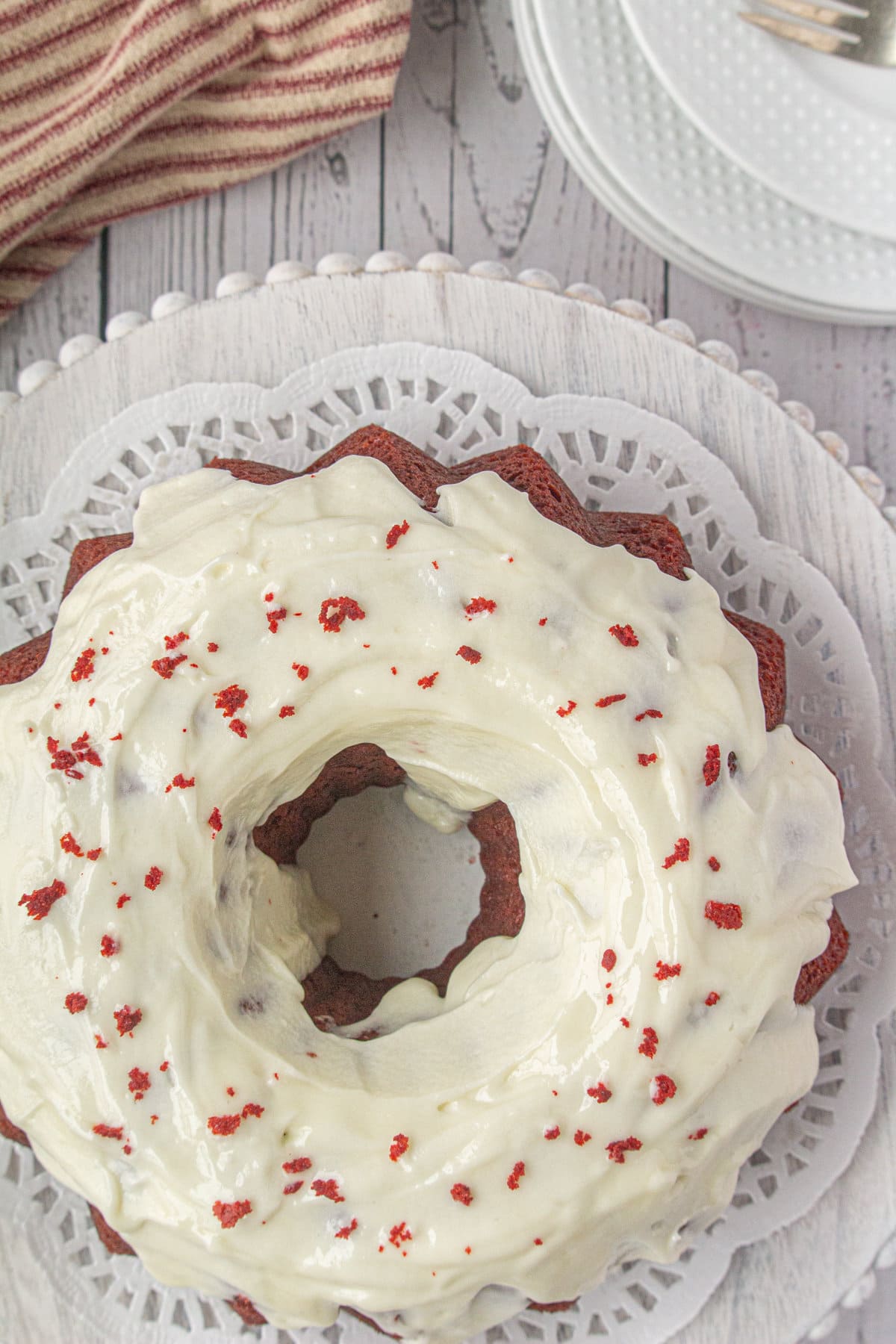 Overhead view of bundt cake with cream cheese frosting.
