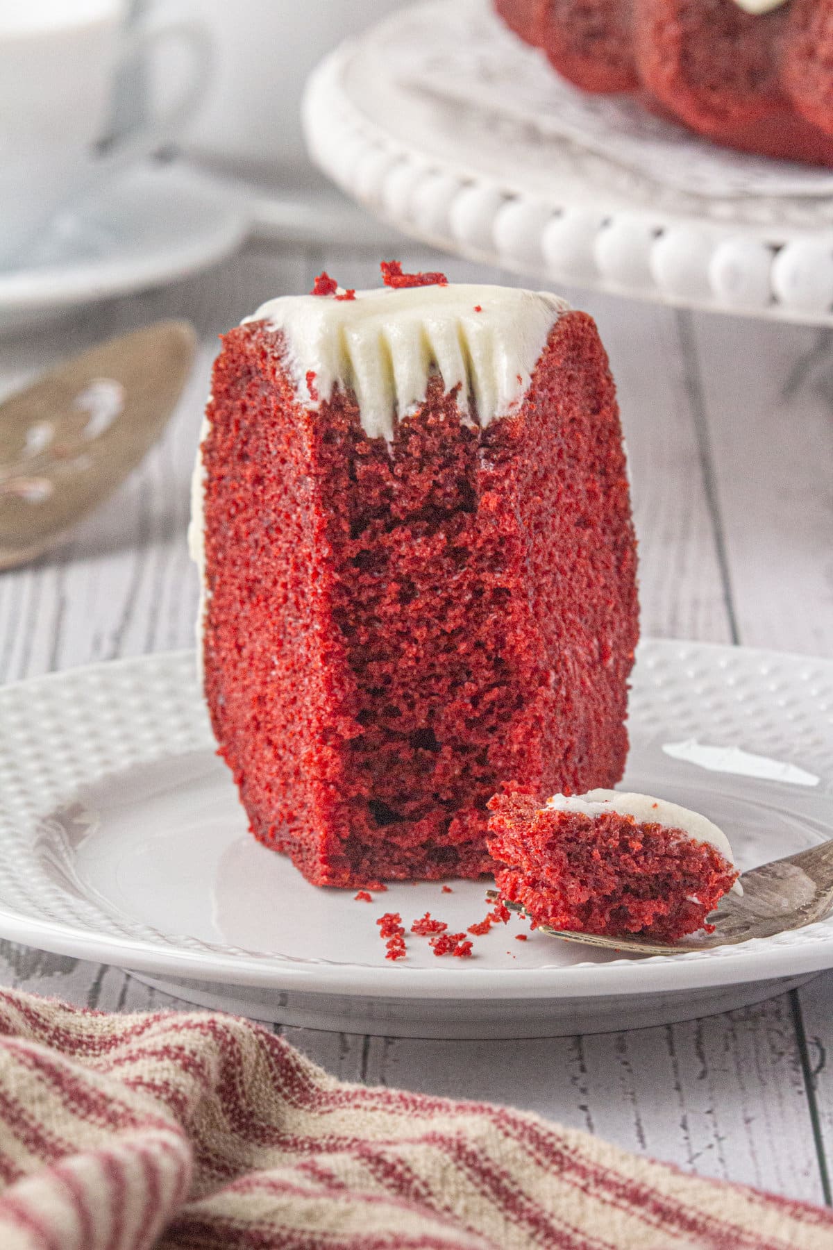 A slice of red velvet bundt cake on a white plate.