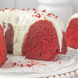 Closeup of the red velvet bundt cake sliced to show bright red interior.