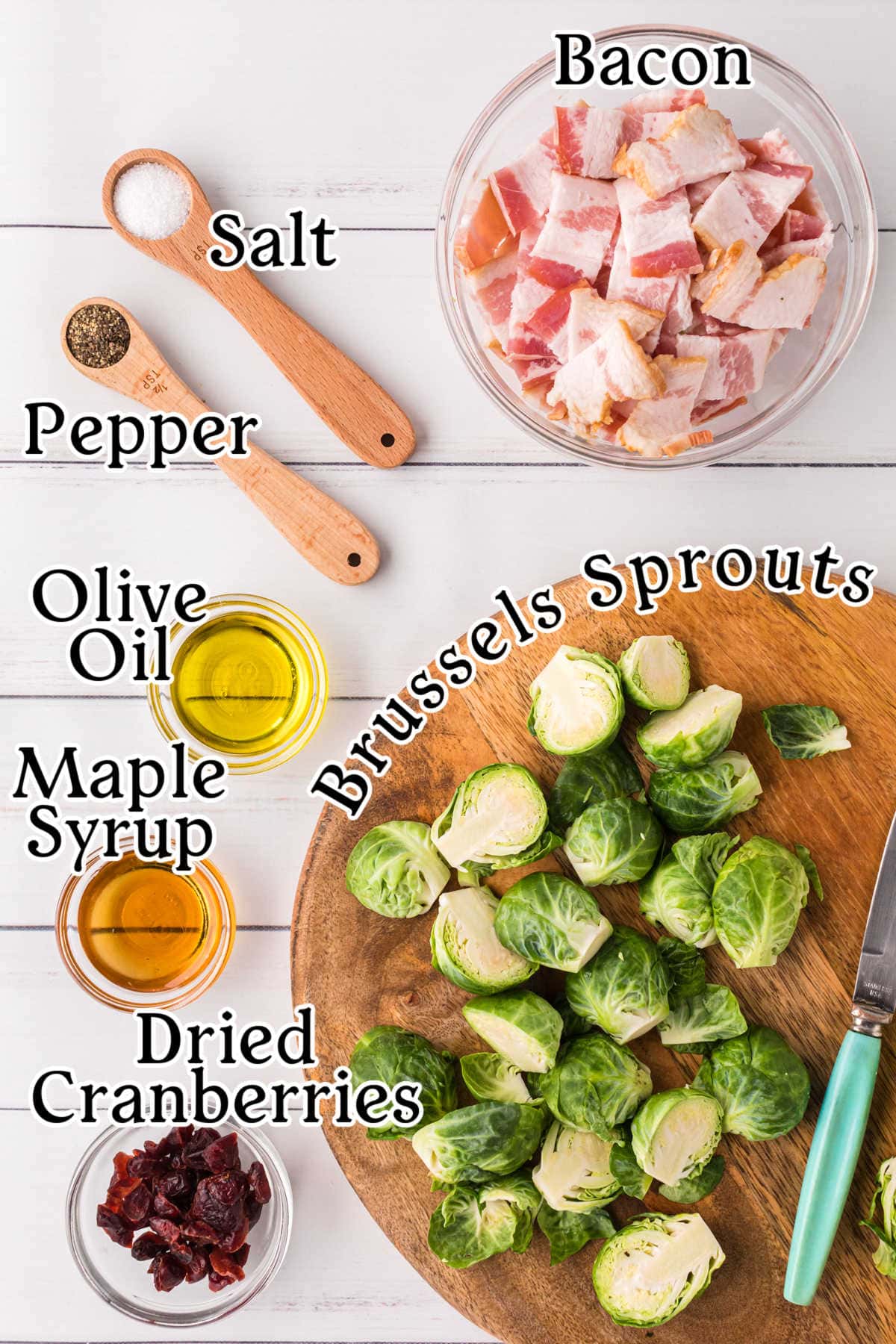 Overhead image with text overlay showing the raw ingredients used to make bacon Brussels sprouts in small bowls and measuring spoons, including Brussels sprouts, bacon, salt, pepper, oil, maple syrup, and cranberries.