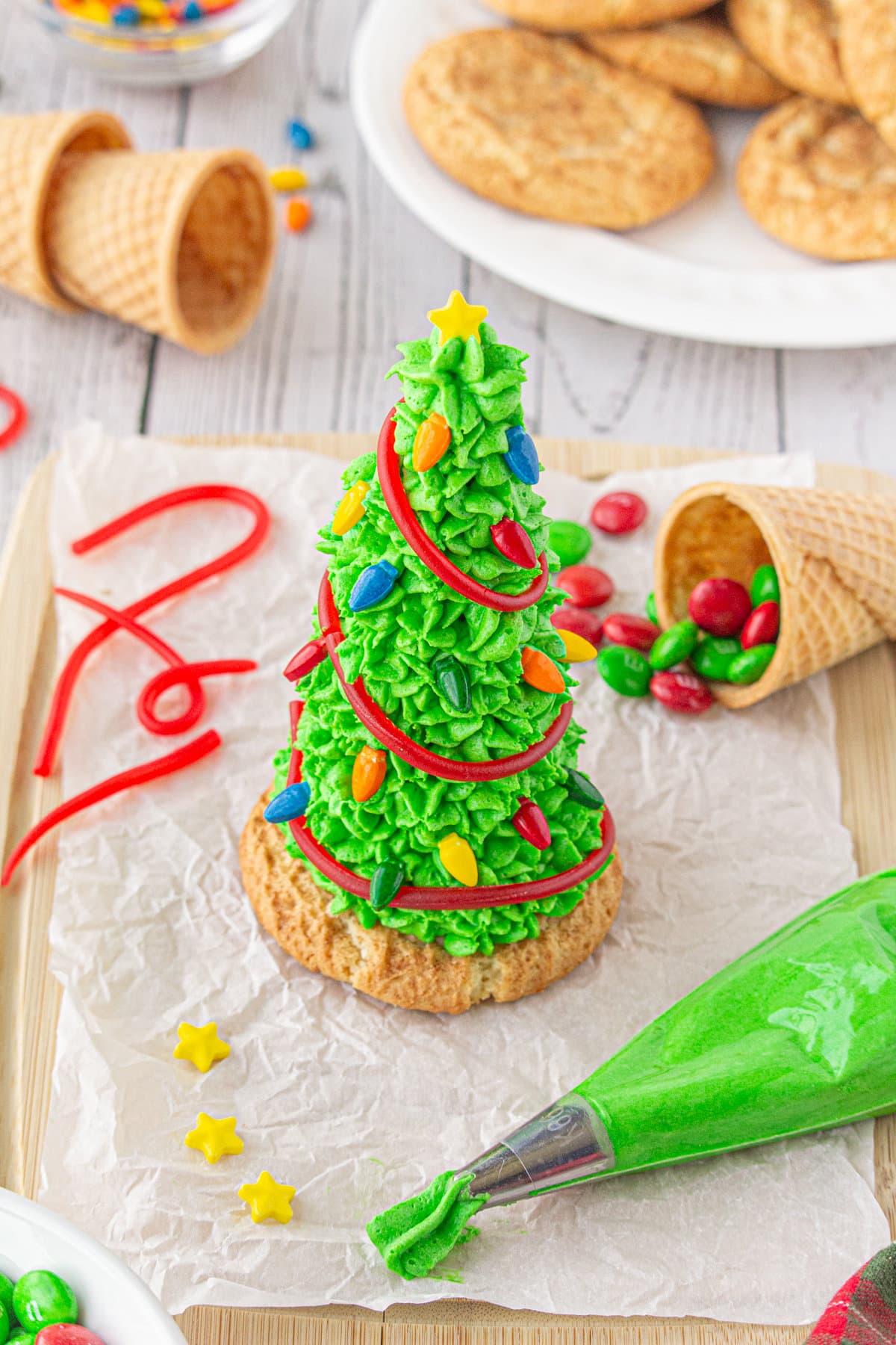 Holiday sprinkles being put on the ice cream cone tree.