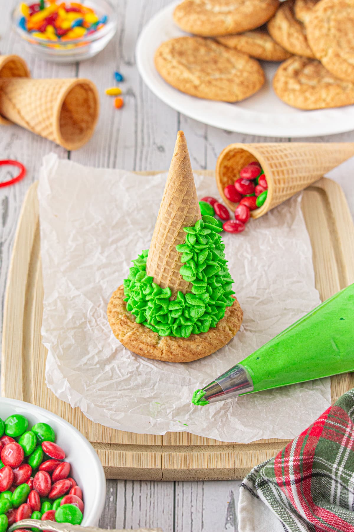 A sugar cone being decorated with royal icing.