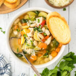 Overhead view of soup bowl filled with turkey and vegetables in a clear broth.