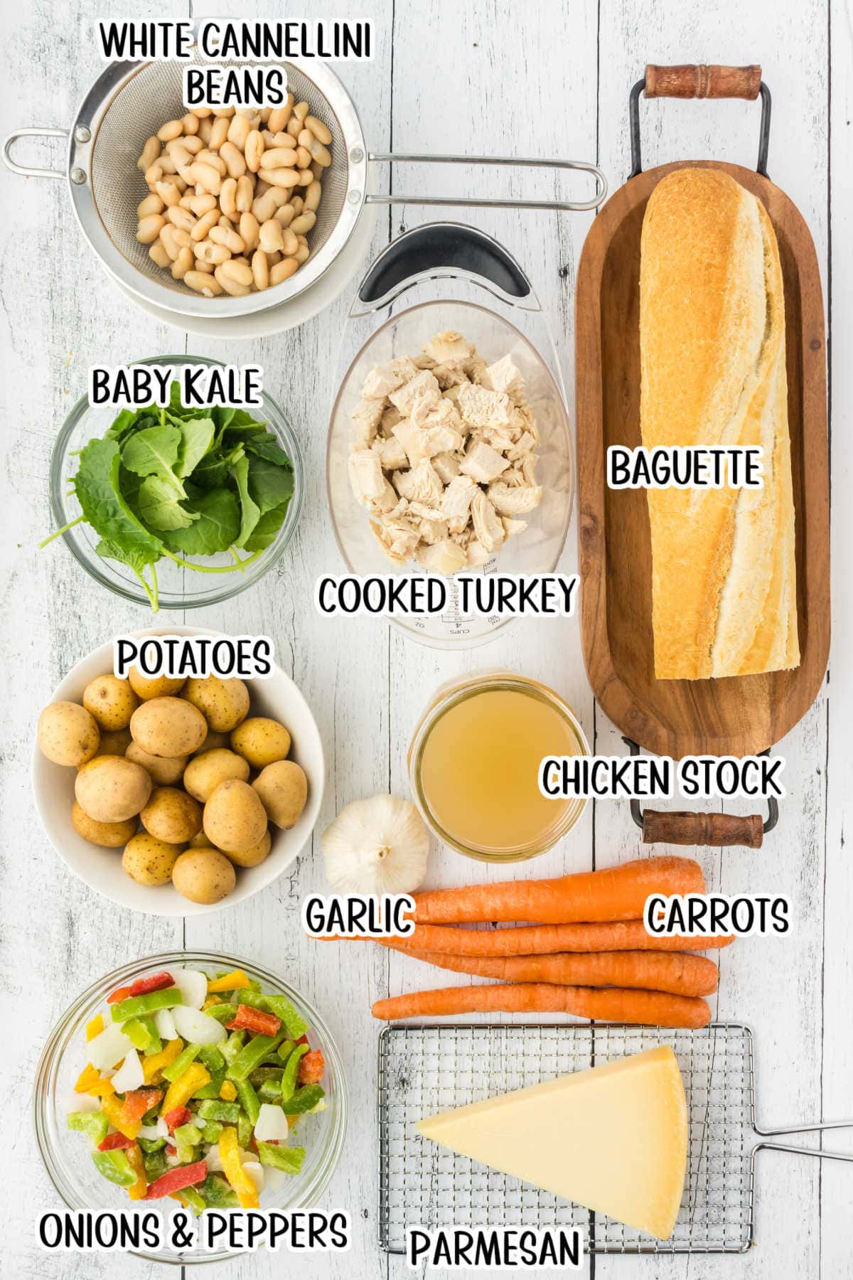 An overhead image showing the raw ingredients used to make Tuscan turkey soup. Each ingredient is labeled with text overlay.