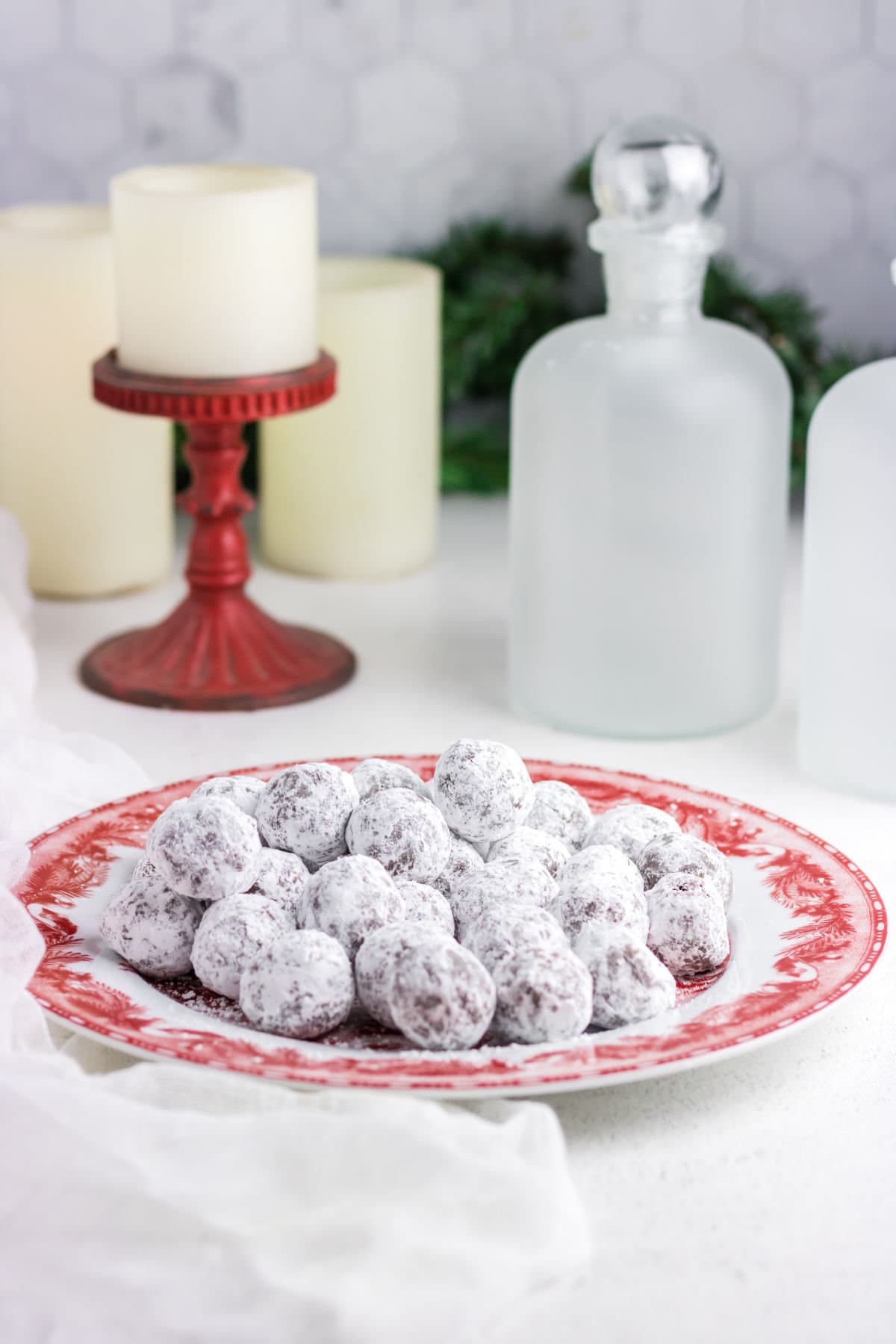 Bourbon balls rolled in powdered sugar on a table.