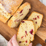 Overhead view of someone picking up a slice of poundcake with a text overlay for Pinterest.