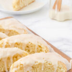 Vanilla scones on a board with title text overlay for Pinterest.