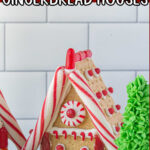 Finished gingerbread house with title text overlay for Pinterest.