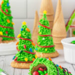 Image of finished sugar cone trees. One is opened with candy spilling out. There's a title text overaly for Pinterest.