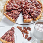 A slice being removed from a pecan pie. Title text overlay for Pinterest.
